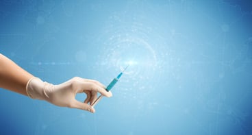 Female doctor hand holding syringe with blue background and shine-1