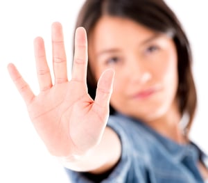 Woman making a stop sign with her hand - isolated  over white